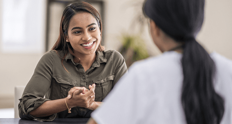 Woman smiling in a wellness conversation